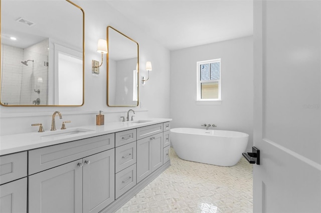 full bath featuring double vanity, a soaking tub, a sink, and a shower stall