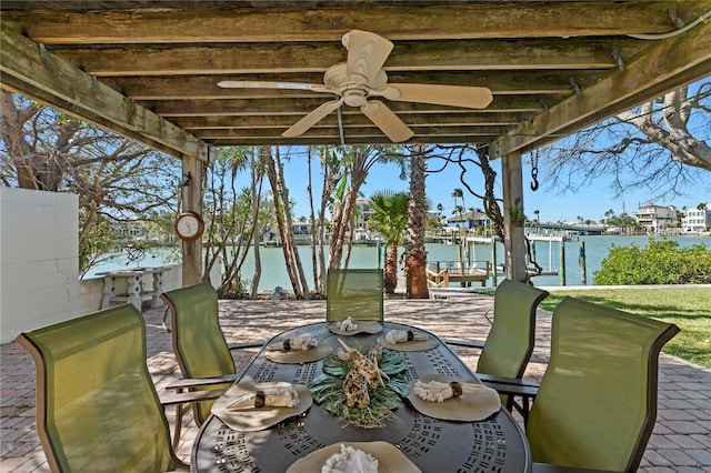 view of patio / terrace with a dock, outdoor dining area, a water view, and a pergola