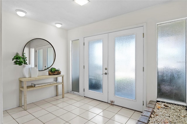 doorway to outside with light tile patterned floors and french doors