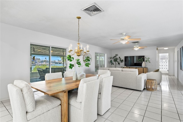 dining area with ceiling fan with notable chandelier, light tile patterned flooring, and visible vents