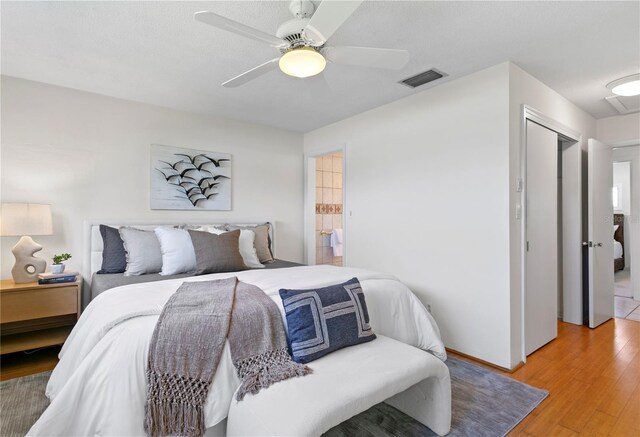 bedroom with ceiling fan, visible vents, and light wood-style floors