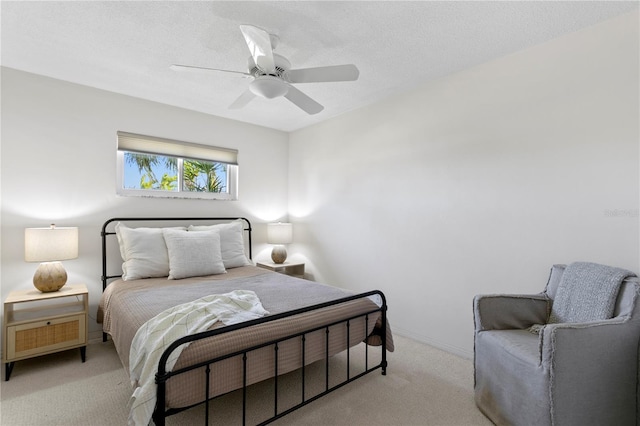 bedroom with a textured ceiling, ceiling fan, carpet, and baseboards