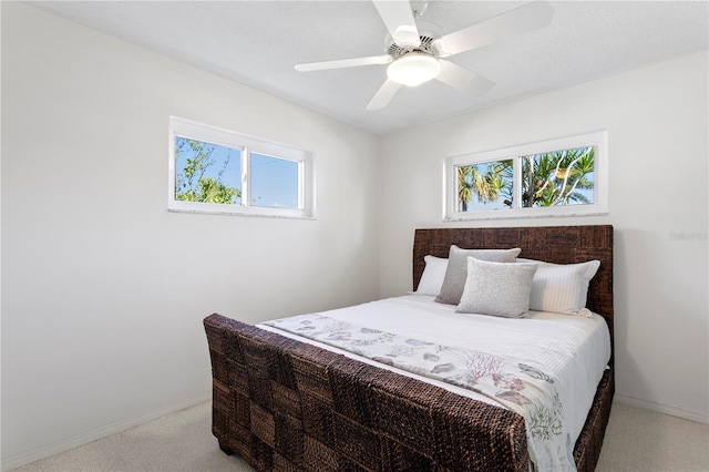 carpeted bedroom featuring ceiling fan and baseboards