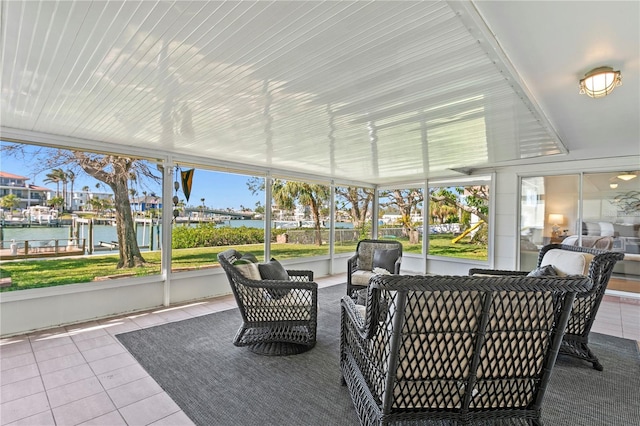 sunroom / solarium with a water view