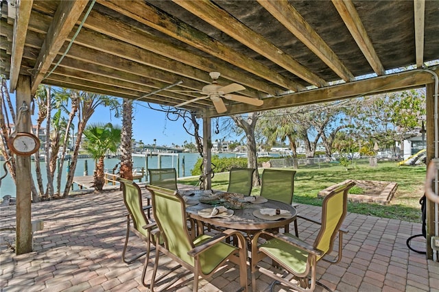 view of patio / terrace with outdoor dining area, a water view, and a ceiling fan