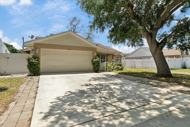 single story home featuring a garage, driveway, a gate, fence, and stucco siding