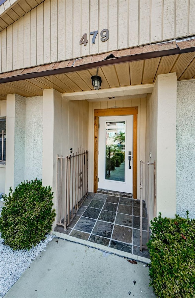 property entrance featuring board and batten siding