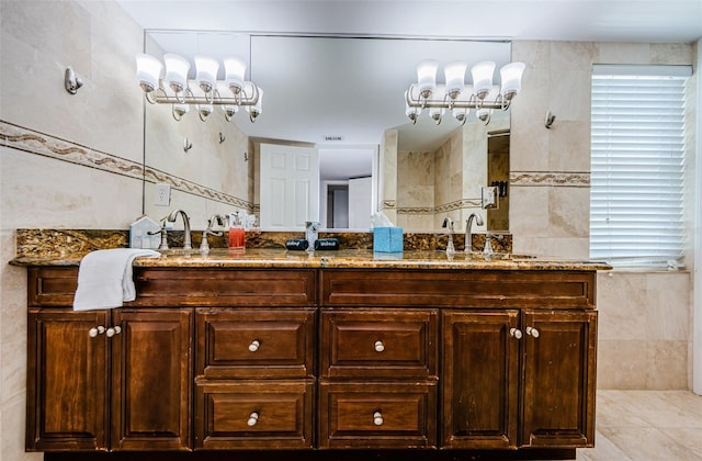 bathroom with a sink, tile walls, a shower, tile patterned floors, and double vanity