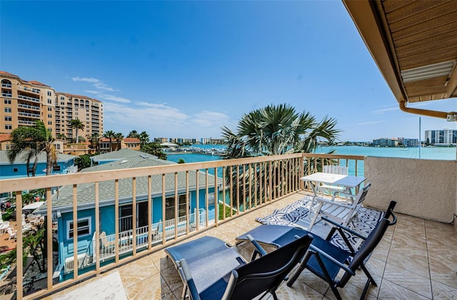 balcony featuring a water view and a city view