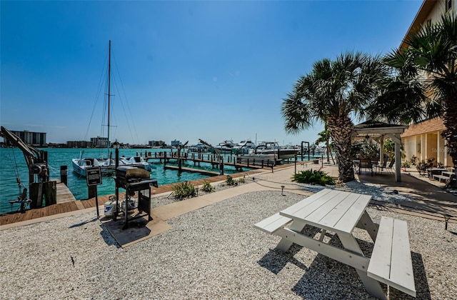 view of property's community with a boat dock and a water view