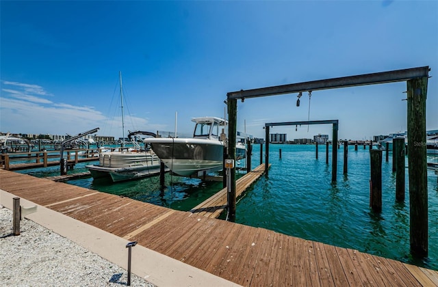 dock area with a water view and boat lift