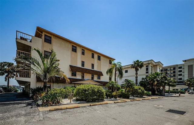 view of property featuring uncovered parking