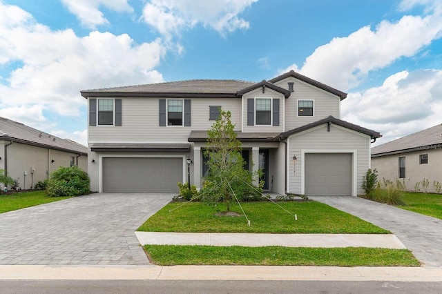 traditional home with a garage, decorative driveway, and a front yard