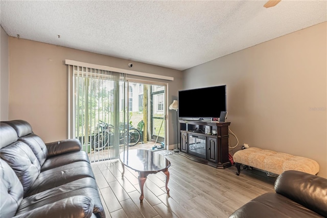 living area with wood finished floors and a textured ceiling