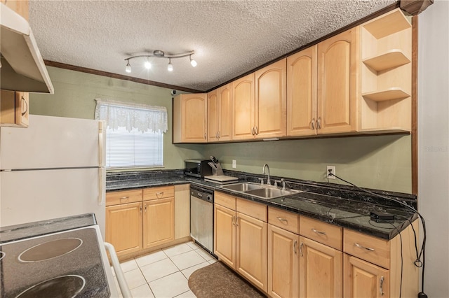 kitchen featuring light brown cabinets, dishwasher, freestanding refrigerator, and a sink