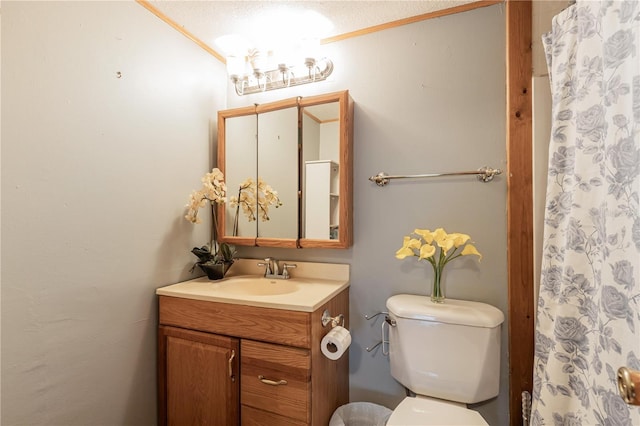 bathroom with vanity, curtained shower, and toilet