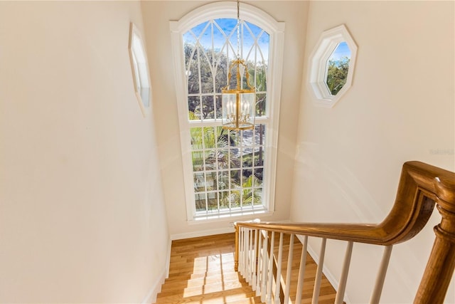 entryway with stairway, light wood-style flooring, and baseboards