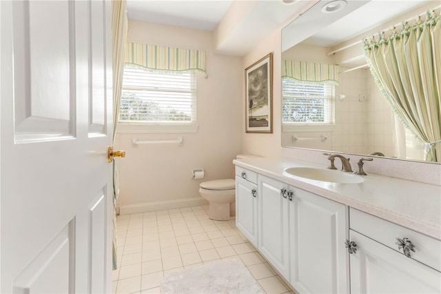 bathroom with tile patterned floors, toilet, a shower with shower curtain, baseboards, and vanity