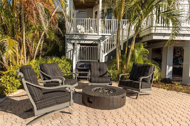 view of patio featuring stairway and a fire pit