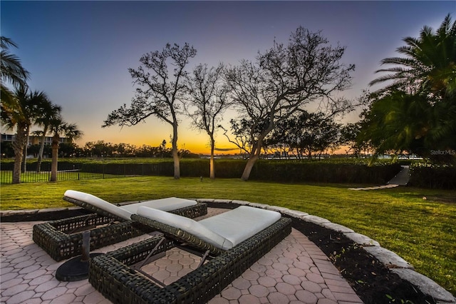 view of home's community featuring a yard and a patio