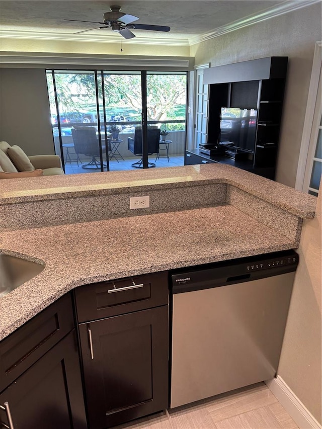 kitchen featuring light stone counters, ornamental molding, a ceiling fan, dishwasher, and baseboards