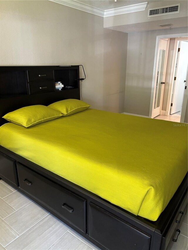 bedroom with visible vents and crown molding