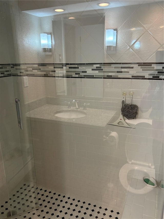 full bath with a stall shower and a sink