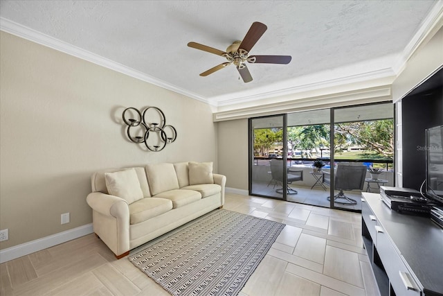 living room with a textured ceiling, a ceiling fan, baseboards, and ornamental molding