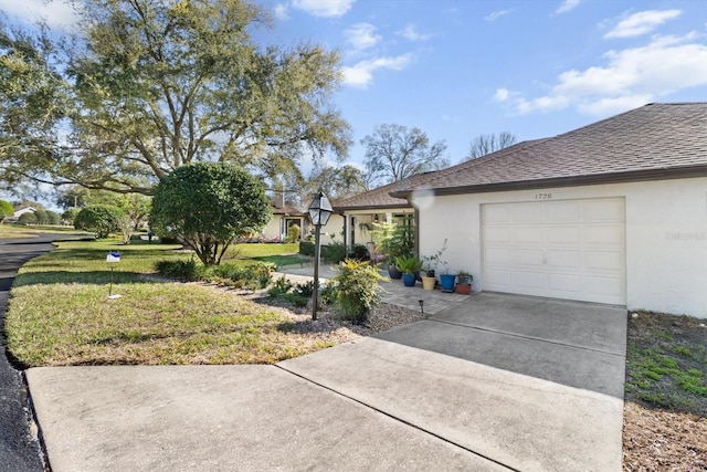 view of front of home featuring driveway, a shingled roof, a front lawn, and stucco siding