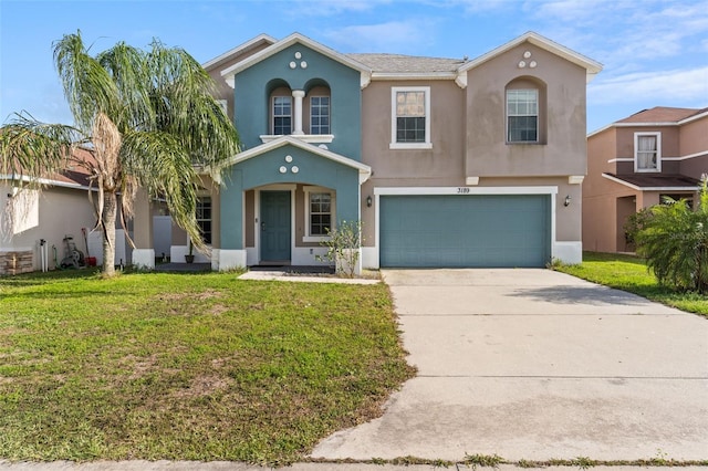 mediterranean / spanish home featuring stucco siding, driveway, a garage, and a front lawn