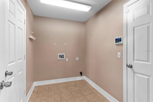 laundry area with baseboards, a textured ceiling, hookup for a washing machine, and laundry area