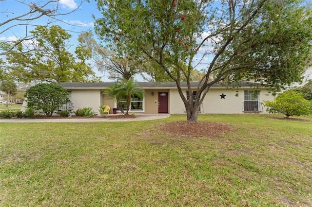 ranch-style house with stucco siding and a front yard