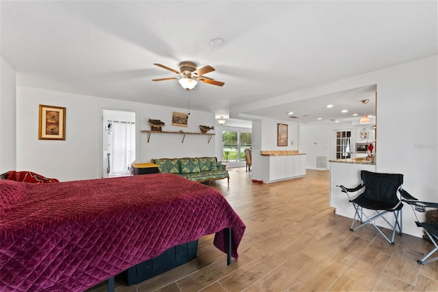 bedroom featuring a ceiling fan, recessed lighting, and light wood-style flooring