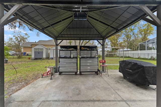 view of parking / parking lot with a shed and fence