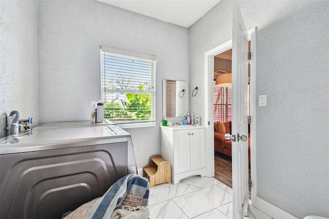 ensuite bathroom featuring marble finish floor, ensuite bath, and vanity