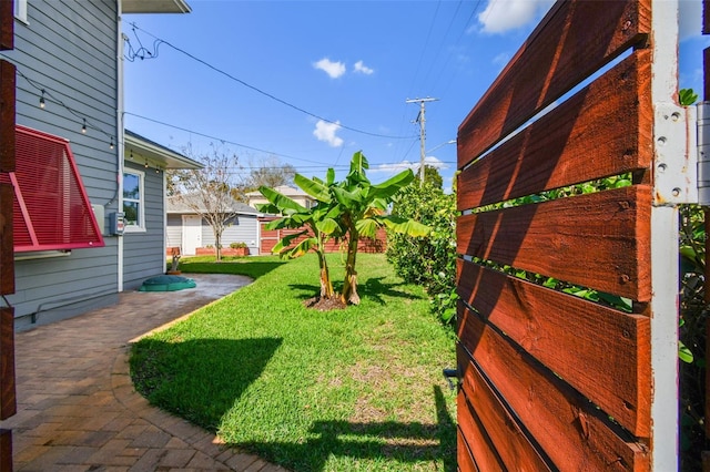 view of yard with a patio and fence