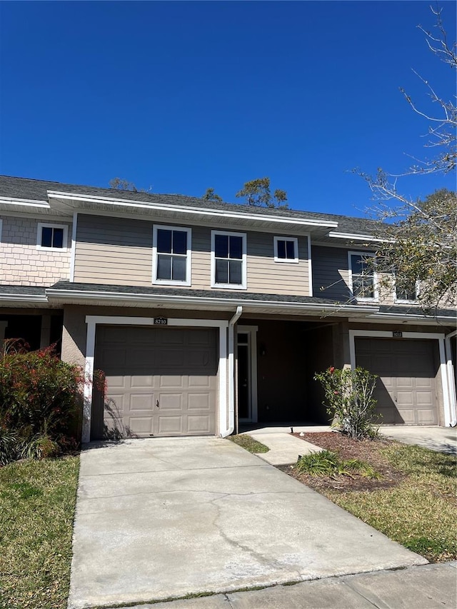 view of front of property featuring a garage and concrete driveway