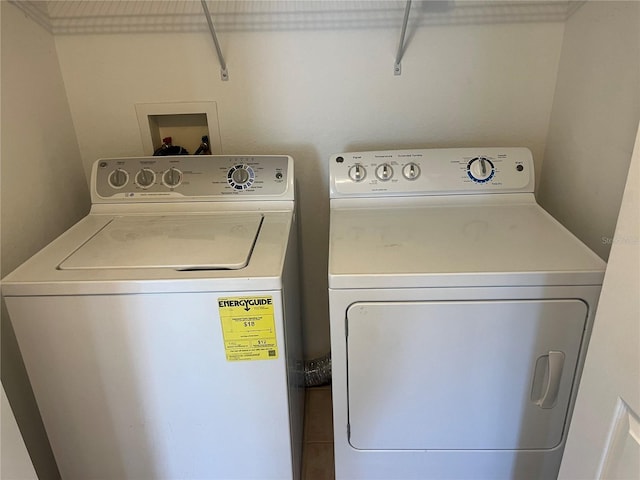 clothes washing area with washer and clothes dryer