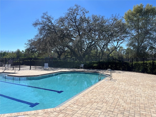 community pool featuring a patio area and fence