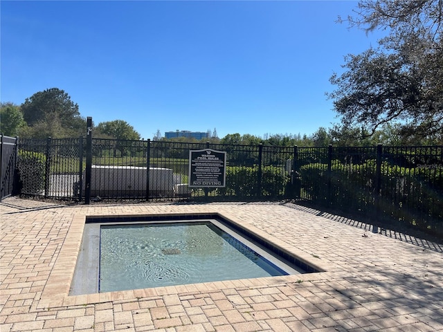 view of swimming pool with fence