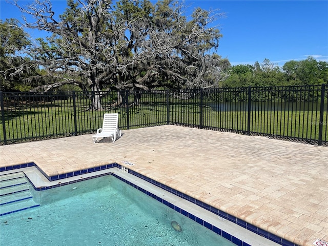 pool with fence and a yard