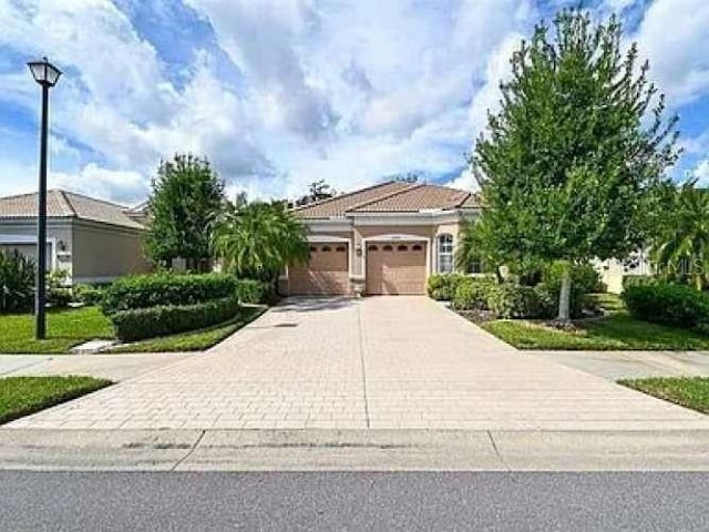 view of front of house featuring a garage and decorative driveway