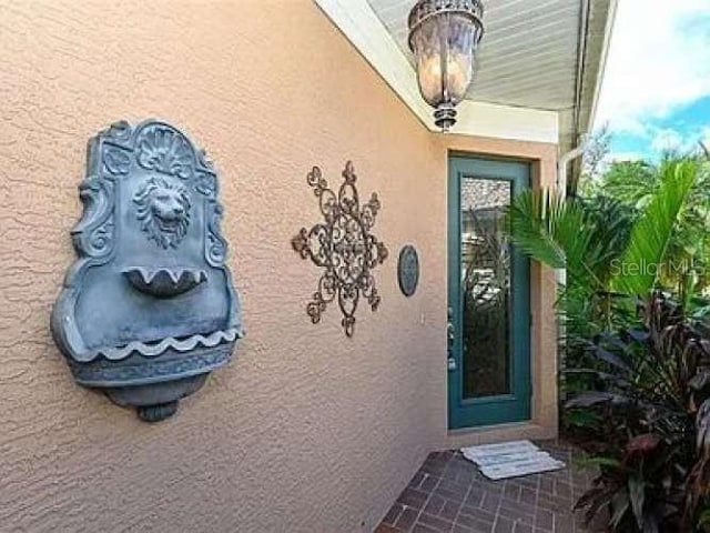 view of exterior entry with stucco siding