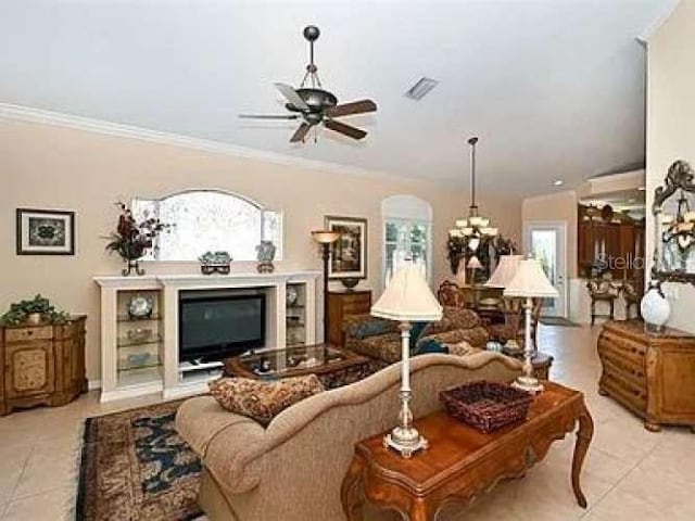 living area featuring a ceiling fan, light tile patterned flooring, crown molding, and visible vents