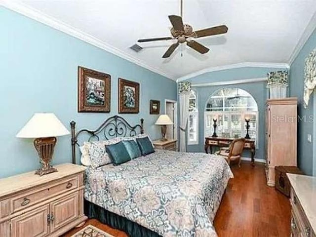 bedroom featuring ceiling fan, visible vents, vaulted ceiling, ornamental molding, and dark wood-style floors