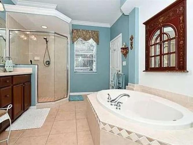 bathroom with ornamental molding, a stall shower, tile patterned flooring, and vanity