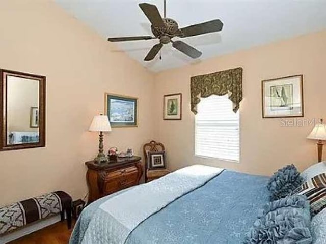 bedroom with lofted ceiling and a ceiling fan