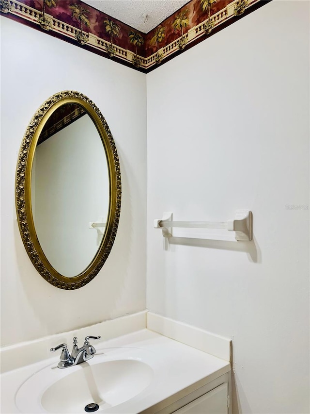 bathroom featuring a textured ceiling and vanity