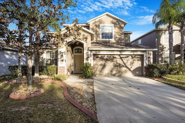 traditional-style home with stone siding, stucco siding, and concrete driveway