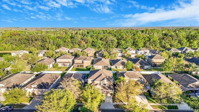 drone / aerial view with a residential view and a forest view